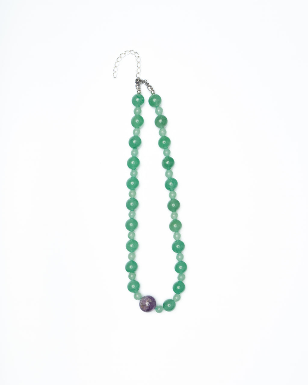 Green beaded necklace with a purple bead on a white background
