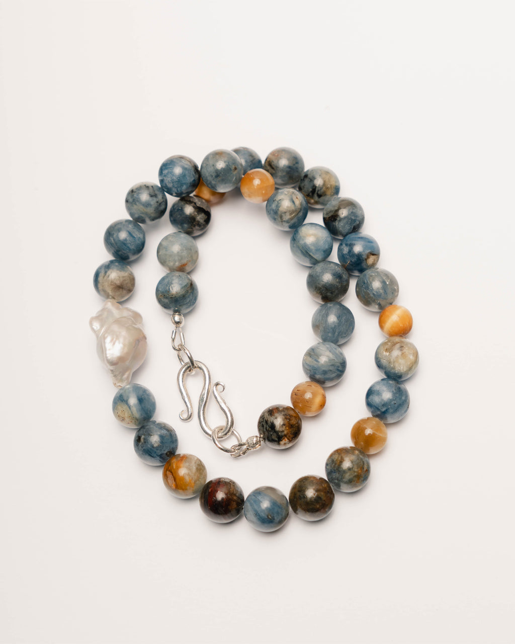 Beaded bracelet with multicolored beads and a silver clasp on a white background