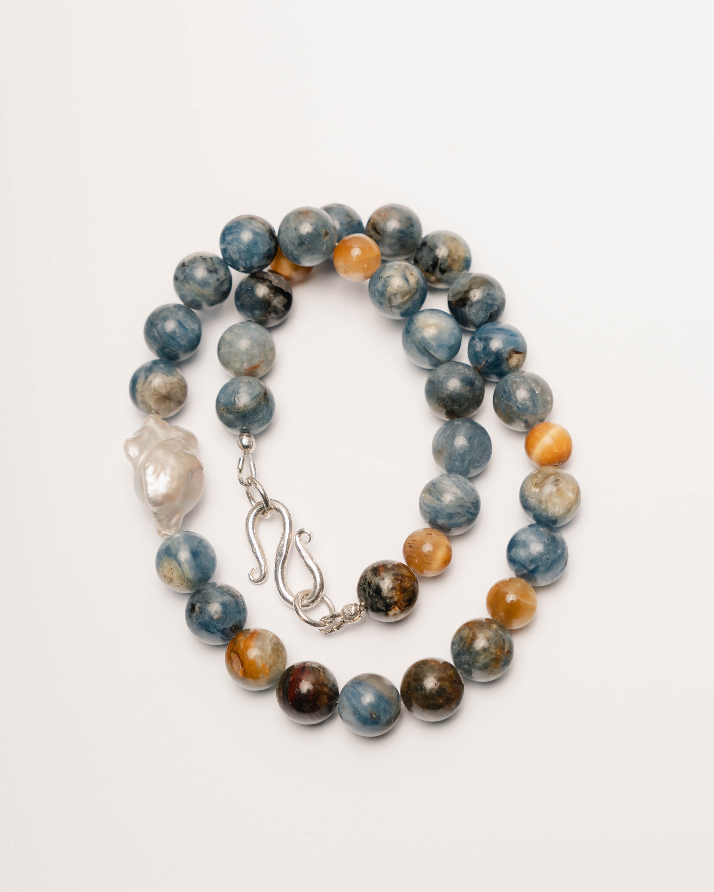 Beaded bracelet with multicolored beads and a silver clasp on a white background