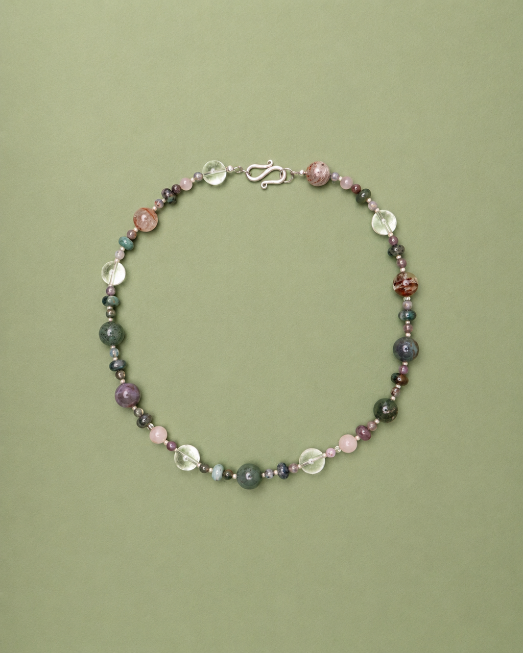 Multicolored beaded necklace on a green background