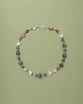 Multicolored beaded necklace on a green background