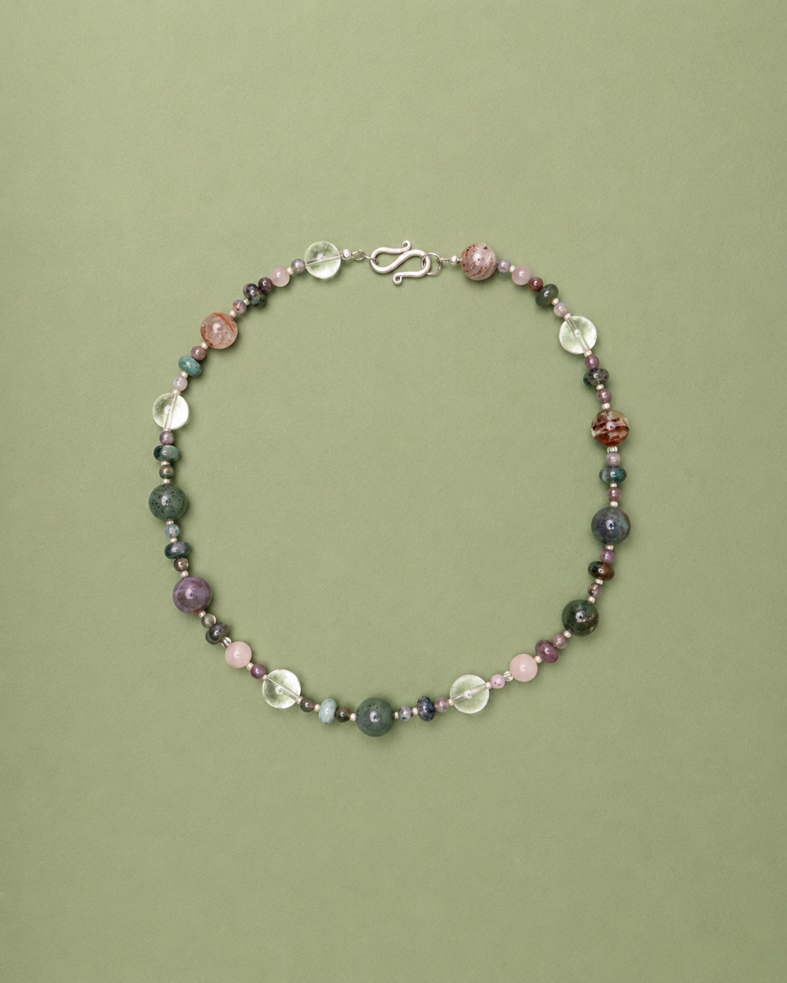 Multicolored beaded necklace on a green background