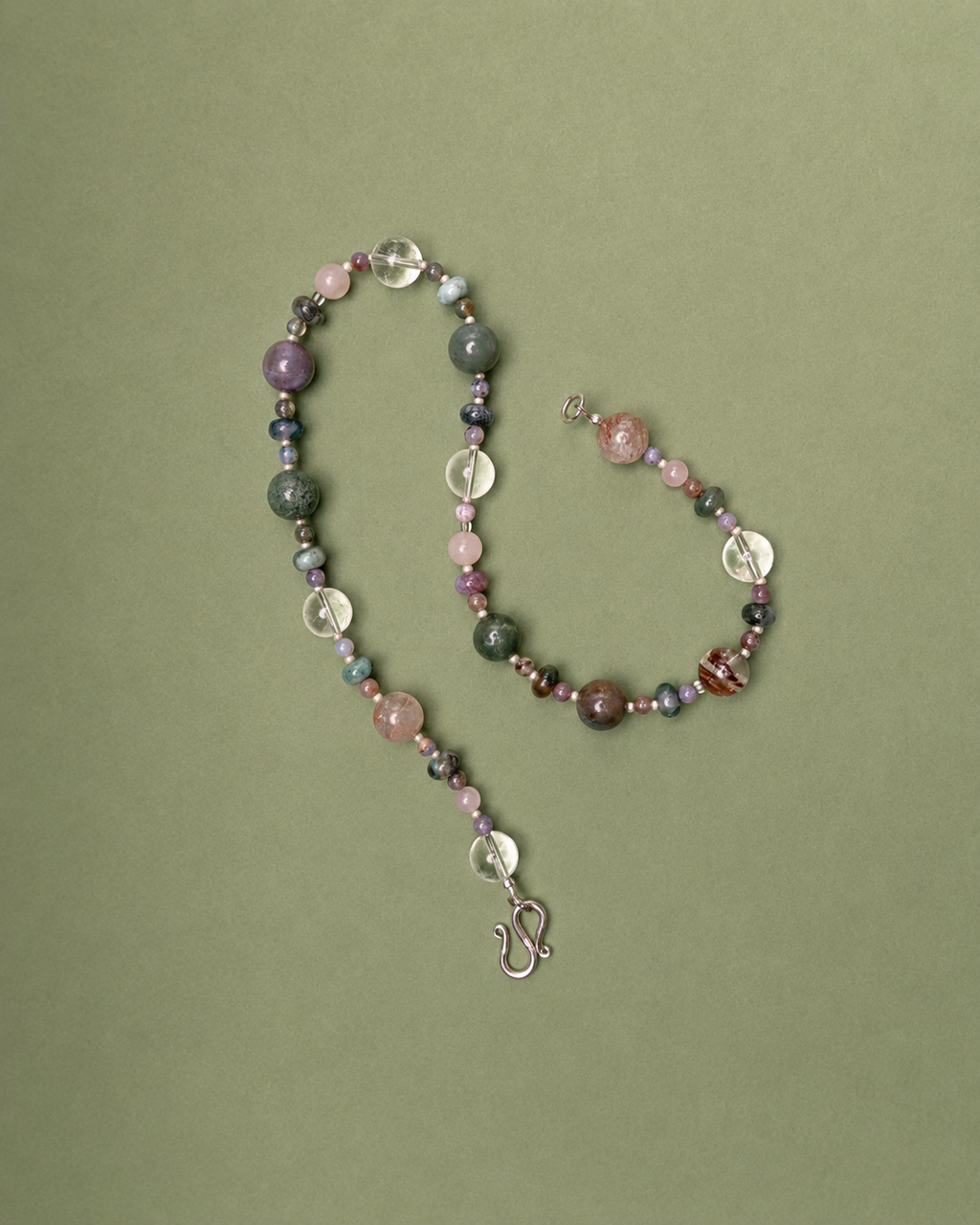 Beaded necklace with a clasp on a green background