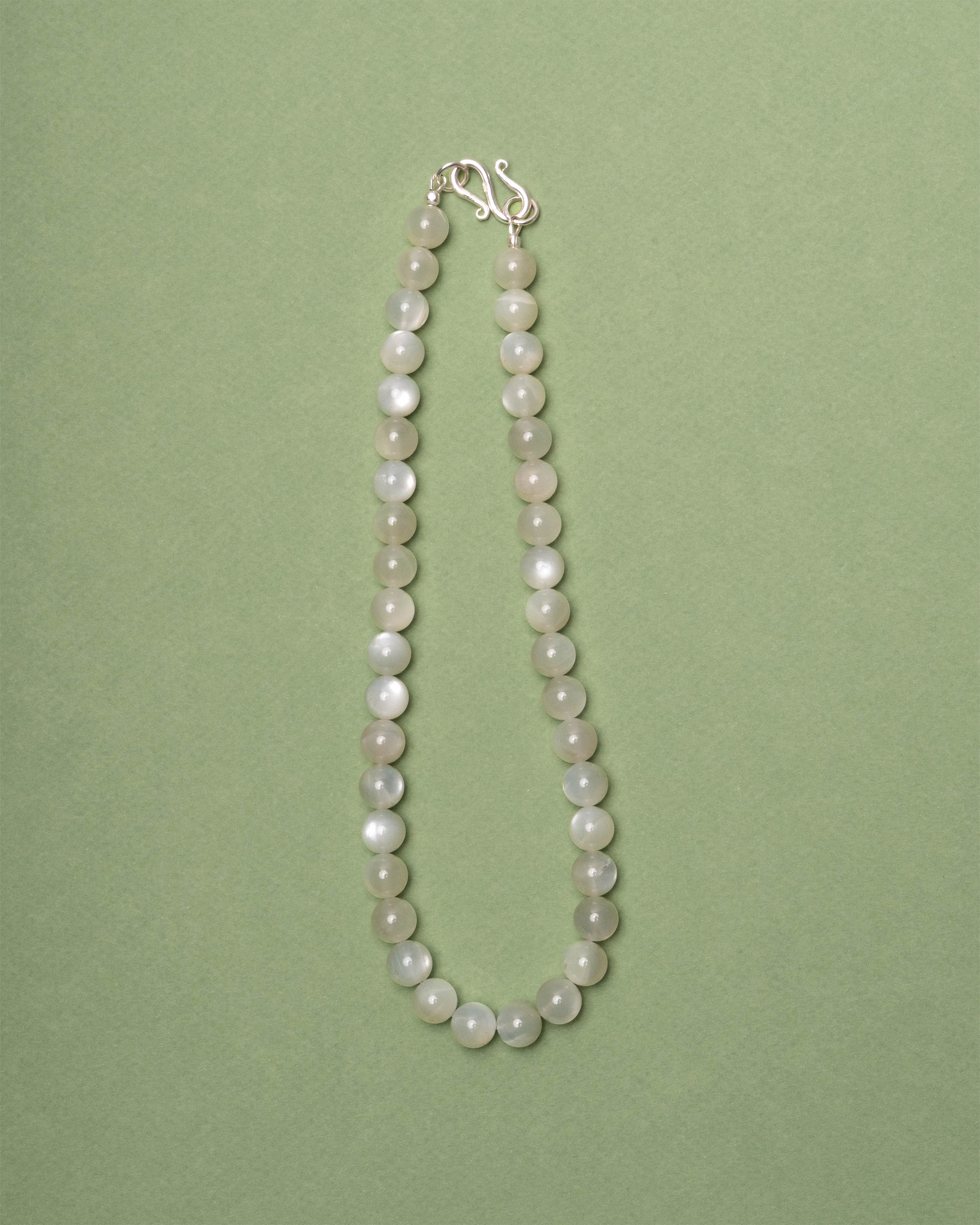 Moonstone necklace on a green background