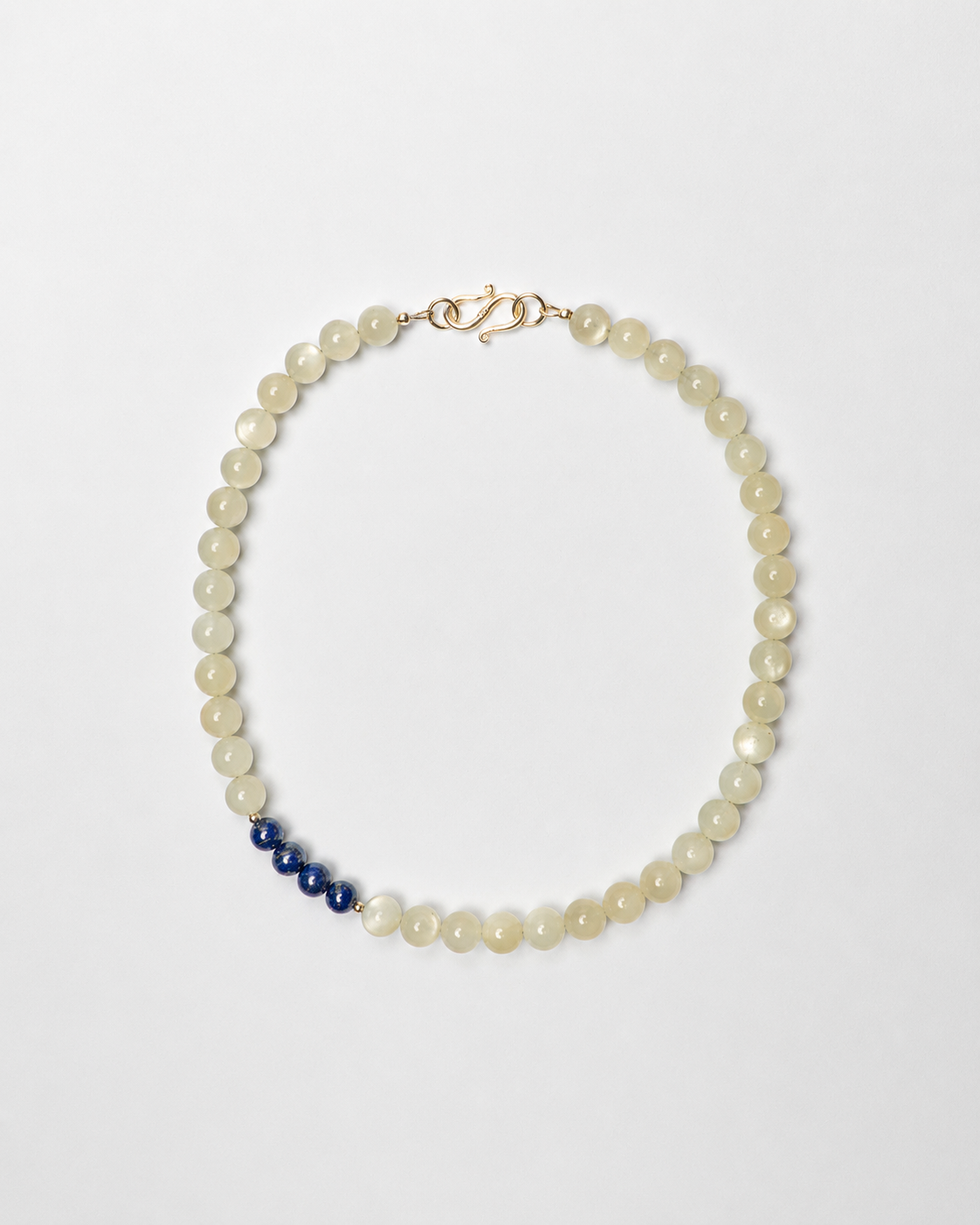Pearl necklace with blue accents on a white background